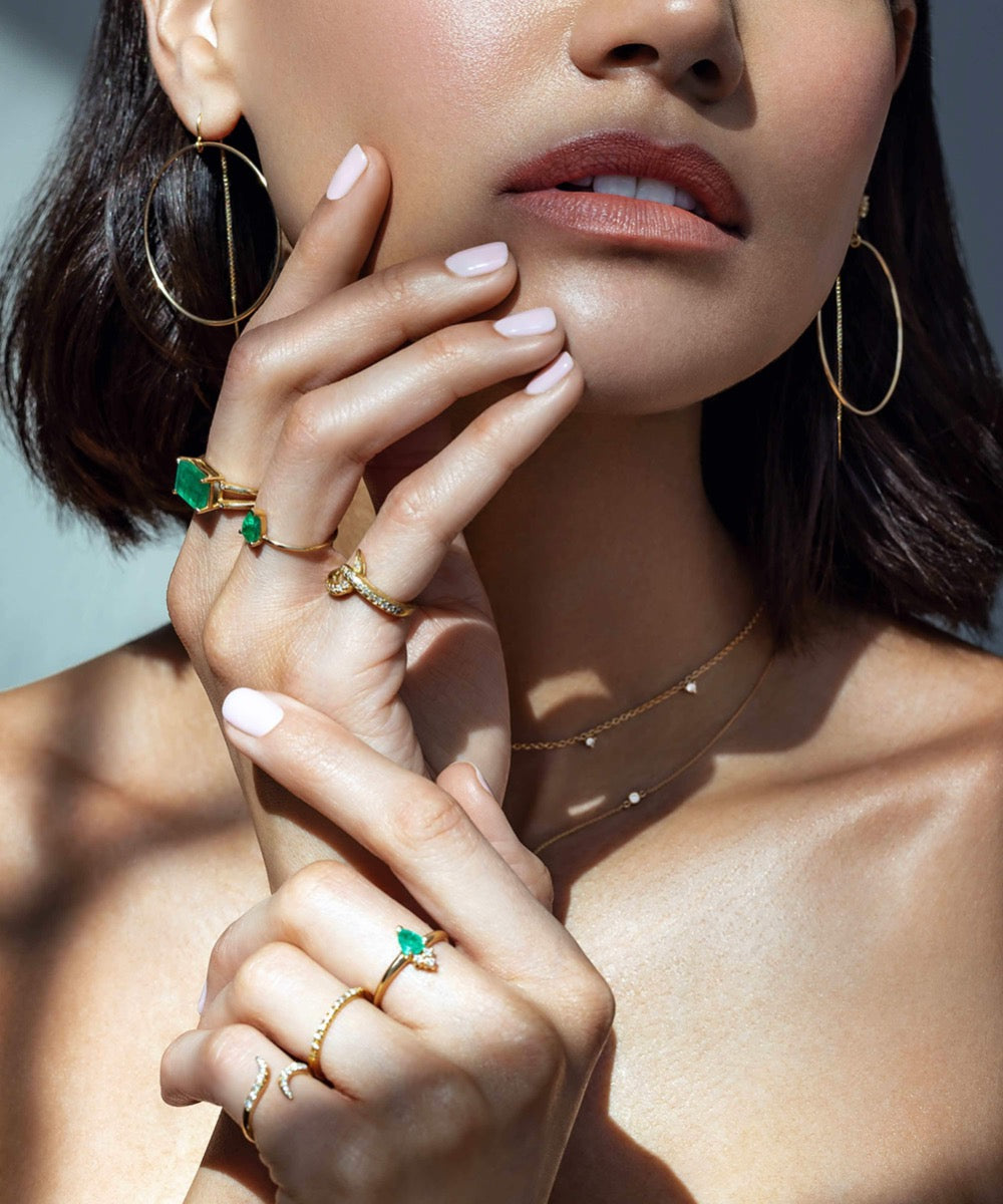 Woman wearing the Emma 14K Gold Double Band Emerald Ring stacked