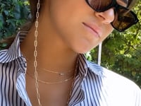 Model wearing convertible gold paperclip chain necklace with sunglasses | Camille Jewelry